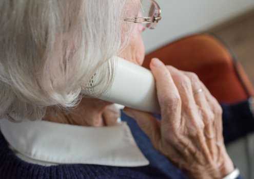 Elderly woman using telephone